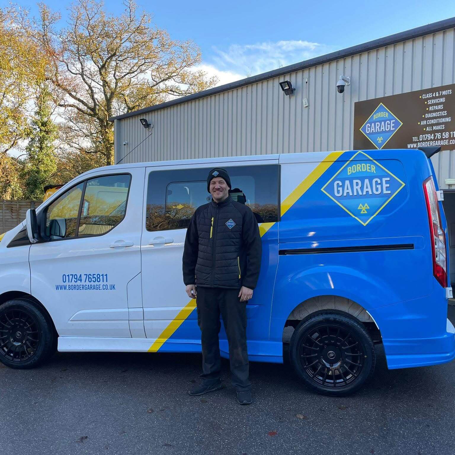 Vehicle servicing technician outside Border Garage in West Wellow